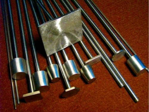 Various metal rods and shapes on a surface