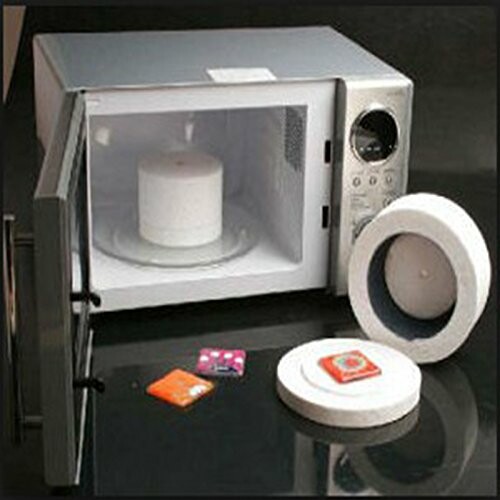 Microwave kiln with open door and accessories including molds.