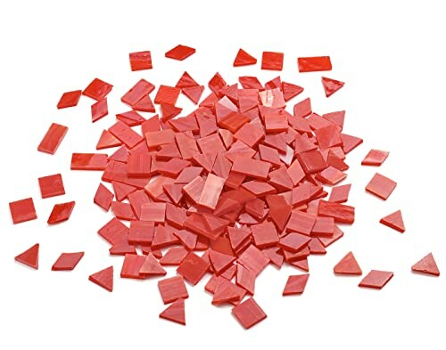 Pile of assorted red glass mosaic tiles in various shapes.